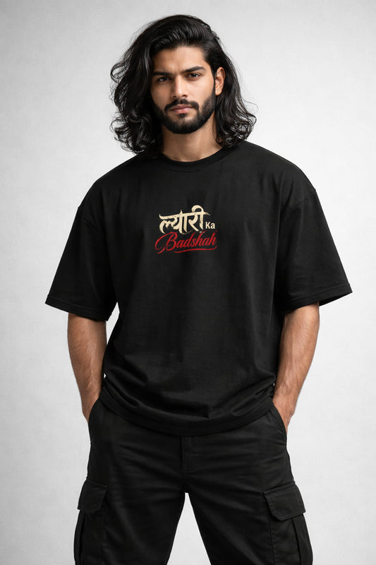 Man wearing a black t-shirt with red and white text on a light gray background