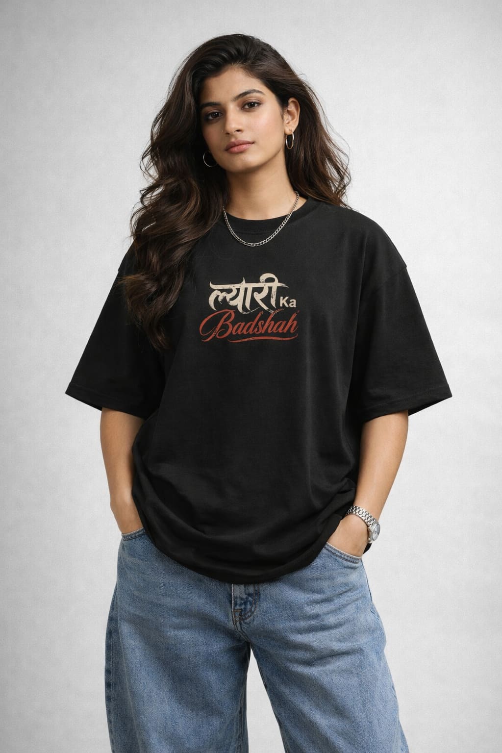 Woman wearing a black t-shirt with text and blue jeans on a plain background