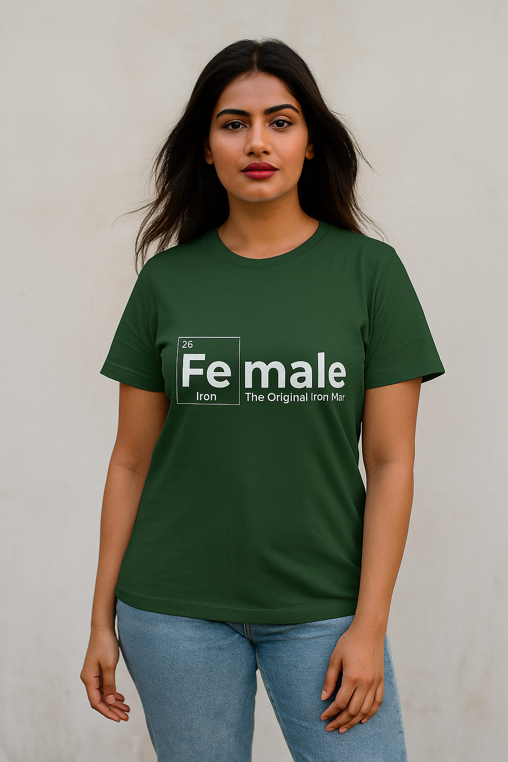 Confident young Indian female model in navy blue oversized T-shirt with ‘Female Iron – The Original Iron Man’ white print, posing stylishly against beige wall. E-commerce fashion mock-up for women’s clothing.
