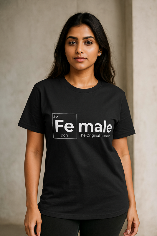 Indian female model wearing oversized black T-shirt with bold white ‘Female Iron – The Original Iron Man’ graphic, standing against textured background. Fashion mock-up for online clothing store.