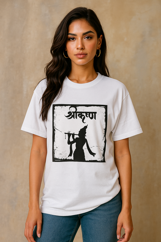 Stylish young Indian woman in her 20s wearing a white oversized T-shirt with a black Krishna silhouette graphic and Hindi text, standing against a textured beige background for an e-commerce fashion photoshoot