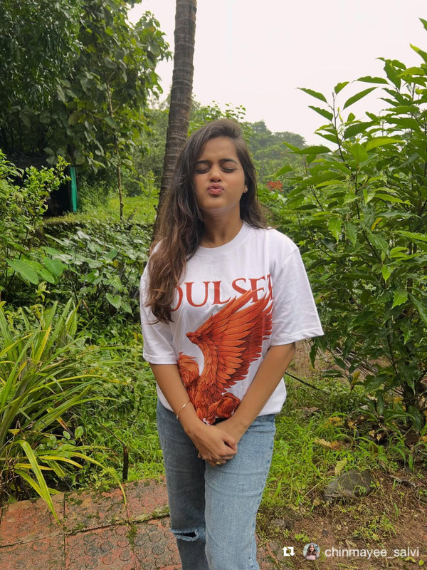 Chinamyee Salvi wearing the Soulset Mynthbourne Tee: a white t-shirt with a pegausus design in a garden setting