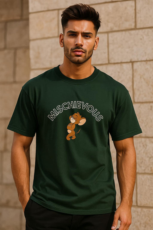 Man wearing a green t-shirt with a graphic and text, standing against a stone wall.