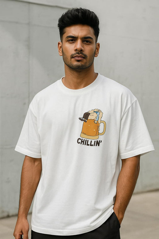 Man wearing a white t-shirt with a graphic design of a mug and text 'Chillin'' against a plain background
