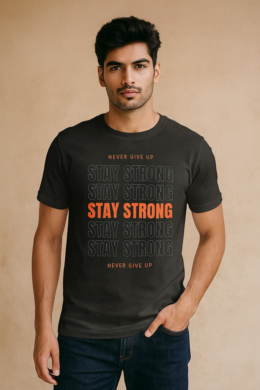 Man wearing a black t-shirt with motivational text on a beige background STAY STRONG
