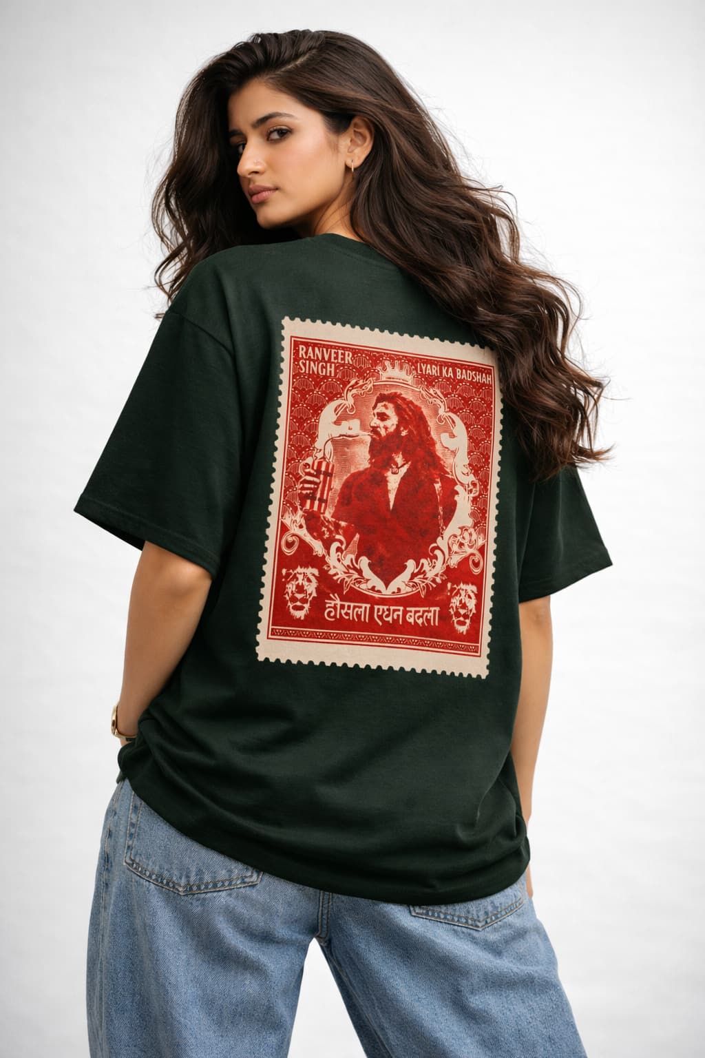 Person wearing a dark green t-shirt with a red and white graphic on the back, standing against a plain background.
