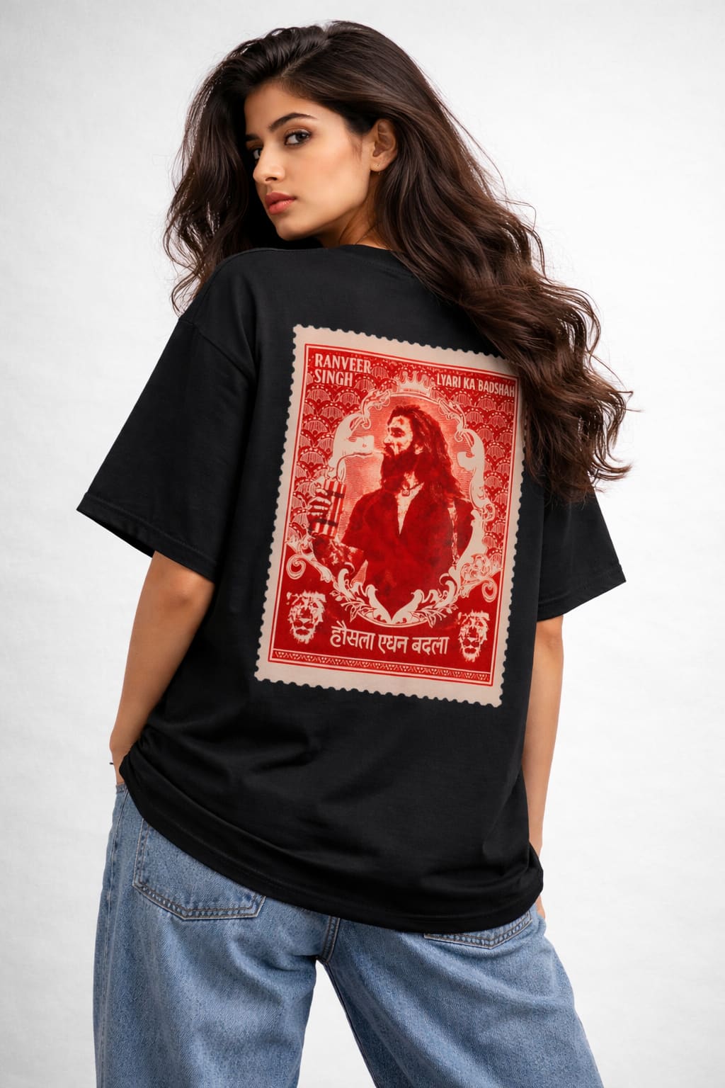 Person wearing a black t-shirt with a red and white graphic on the back, standing against a plain background.