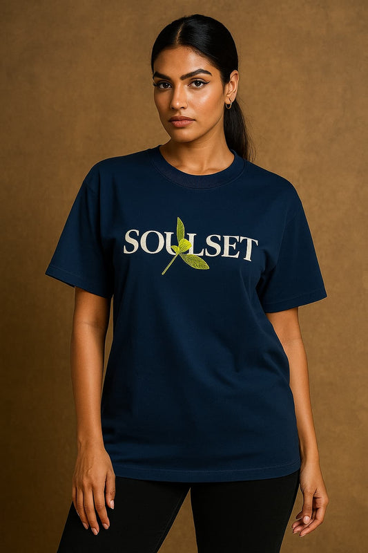 Person wearing a navy blue t-shirt with 'Soulset' logo on a brown background