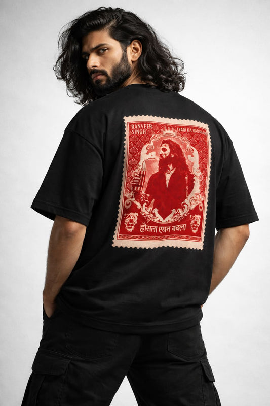 Person wearing a black t-shirt with a red graphic on the back against a white background