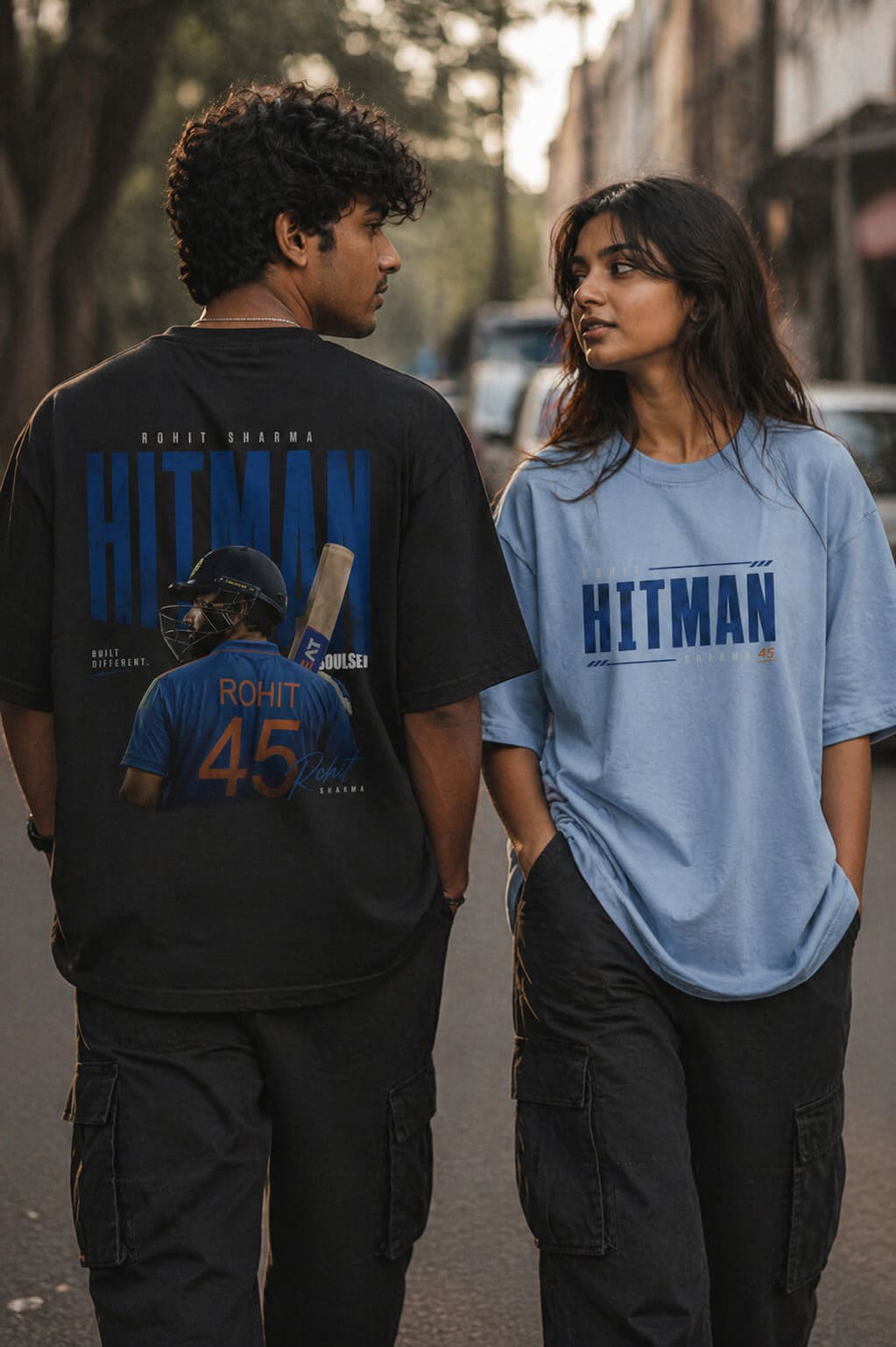 Two people wearing 'Hitman' t-shirts with a sports theme, one black and one blue.